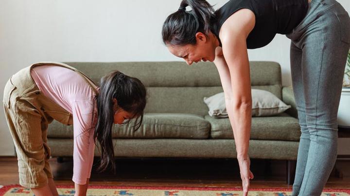 Woman stretching with her daughter