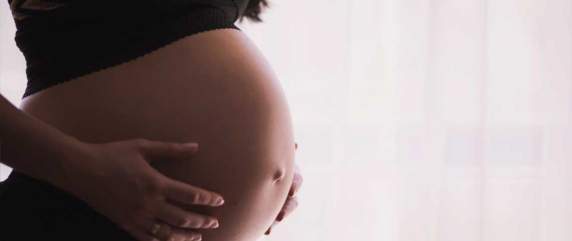 Pregnant Woman Holding Stomach - Sun Chlorella USA
