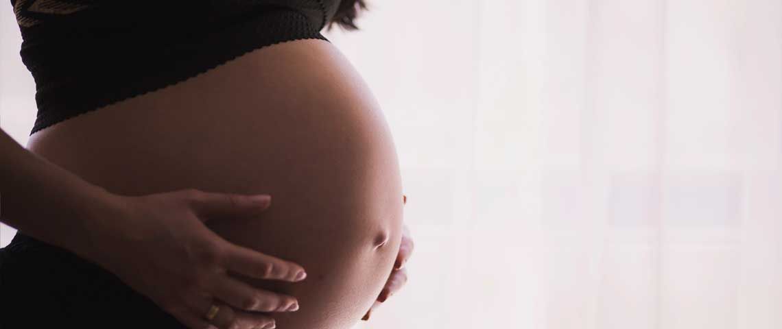Pregnant Woman Holding Stomach - Sun Chlorella USA Pregnant Woman Holding Stomach - Sun Chlorella USA