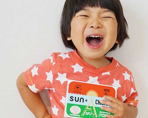Child holding a Sun Chlorella package - Sun Chlorella USA