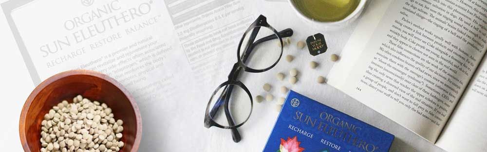 Sun Eleuthero Tablets by a Book and Glasses