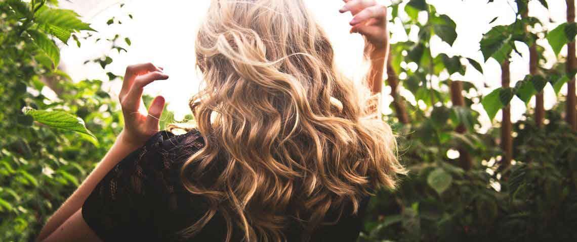Woman showing off healthy hair - Sun Chlorella USA Woman showing off healthy hair - Sun Chlorella USA