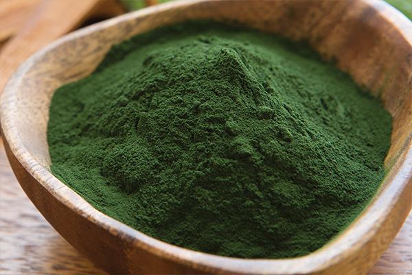 Sun Chlorella Powder in a wooden bowl