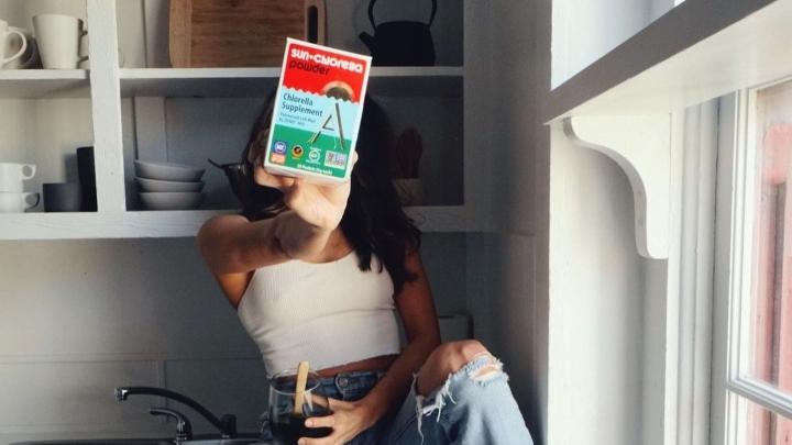 Woman holding chlorella product