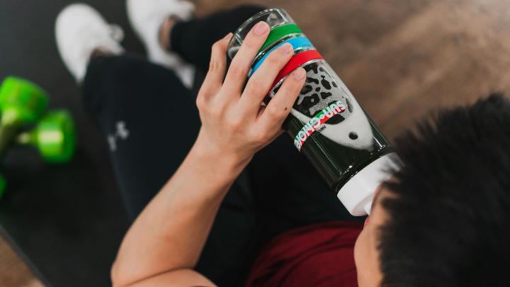 A picture of a male drinking out of a Sun Chlorella bottle