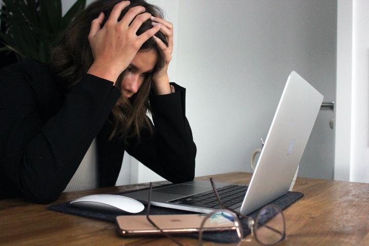 Woman stressed out looking at her computer