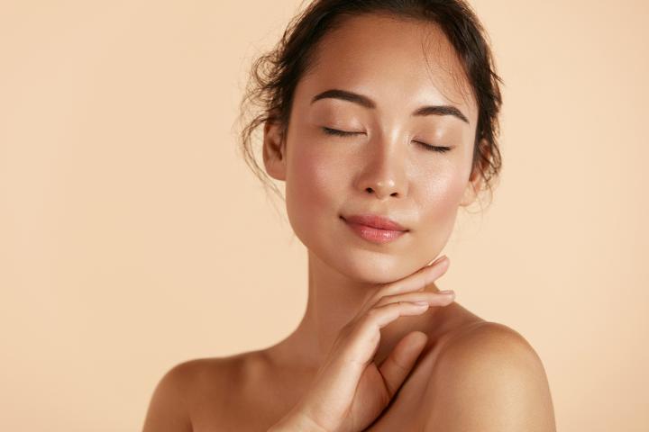 Woman with her eyes closed resting her head on her hand