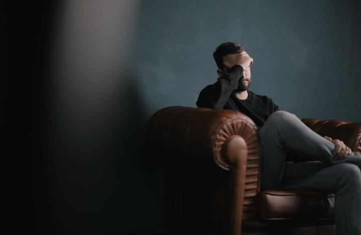 Man stressed on a couch