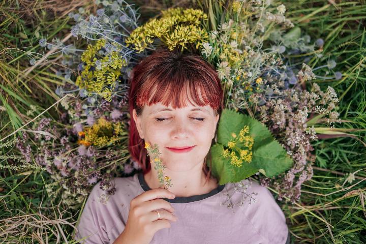 Woman happily laying amongst flowers