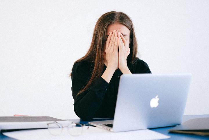 Woman stressed out working on her computer