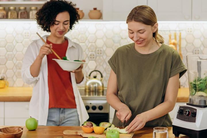 Two friends making a meal together