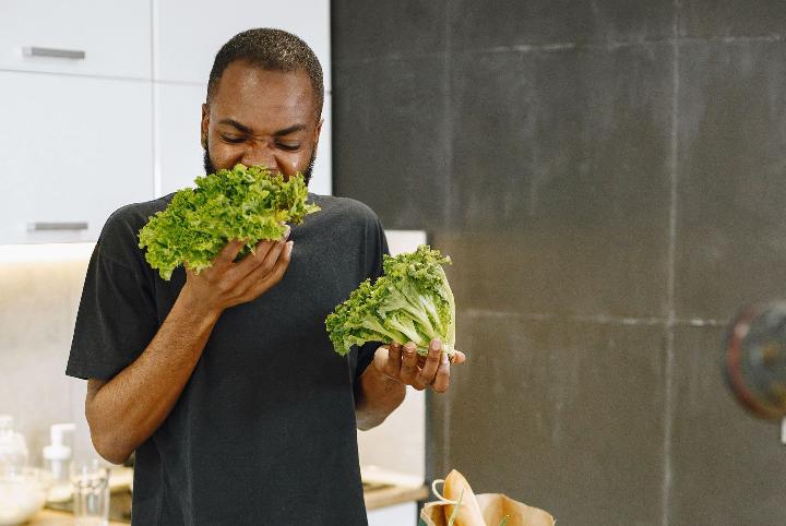 Man eating leafy greens