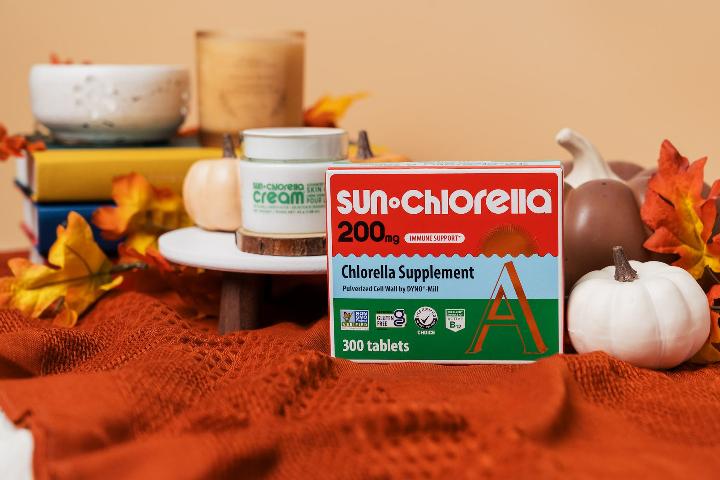Sun chlorella Cream and Sun Chlorella Tablets displayed in a fall theme