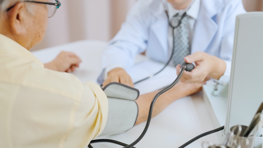 Senior patient getting his blood pressure checked 